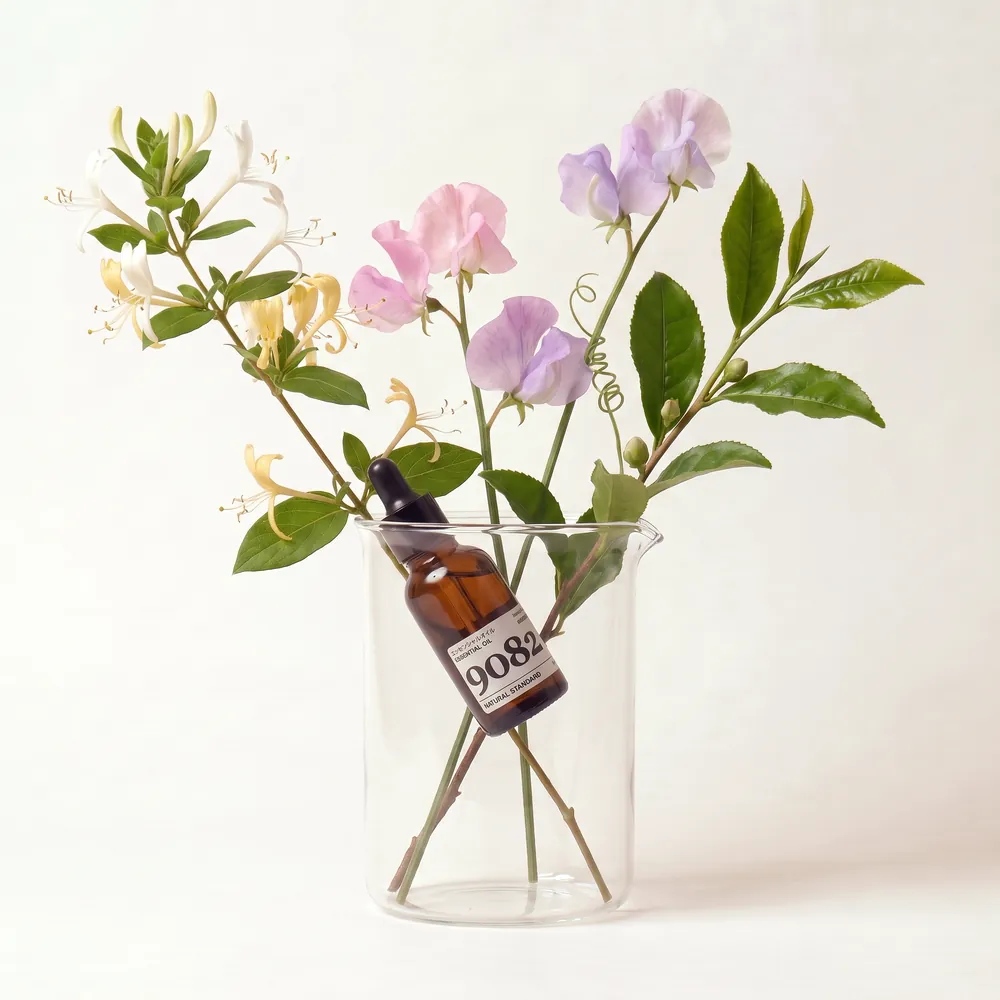 Essential Oil Blend No.9082, Nine Zero Eight Two · essential oil bottle arranged with ingredients | Lê Mai