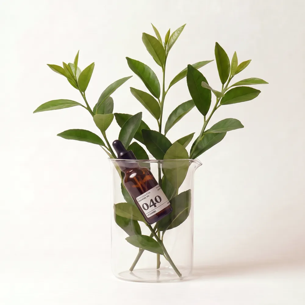 Lemon Leaf Essential Oil No.040 · bottle in a glass of ingredients | Lê Mai