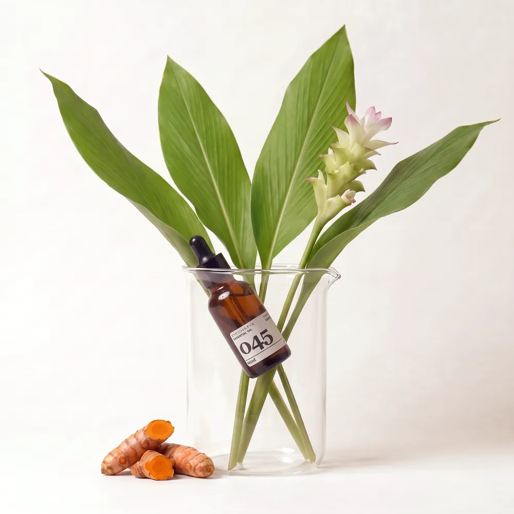 Turmeric Essential Oil No.045 · bottle in a glass of ingredients | Lê Mai
