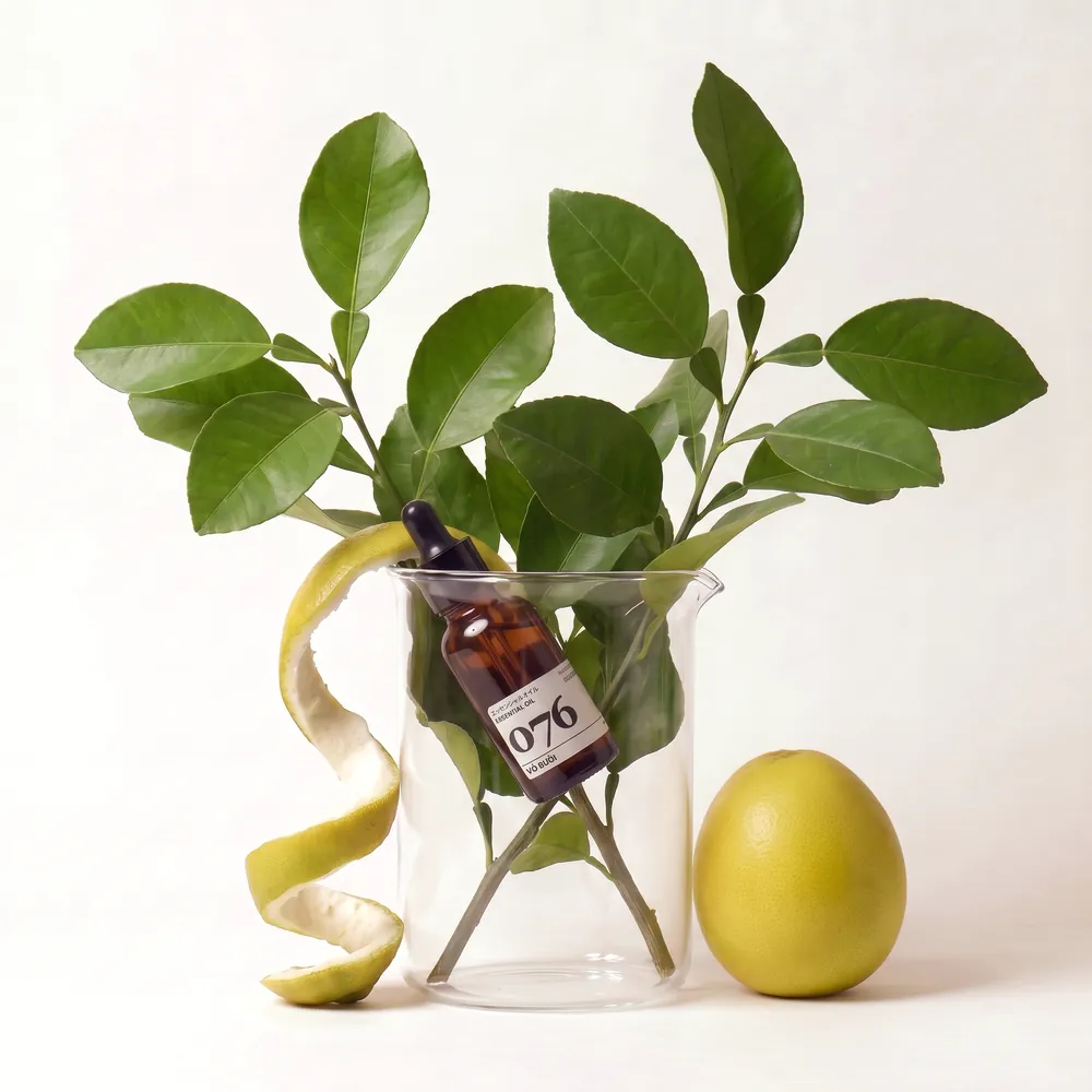 Pomelo Essential Oil No.076 · bottle in a glass of ingredients | Lê Mai
