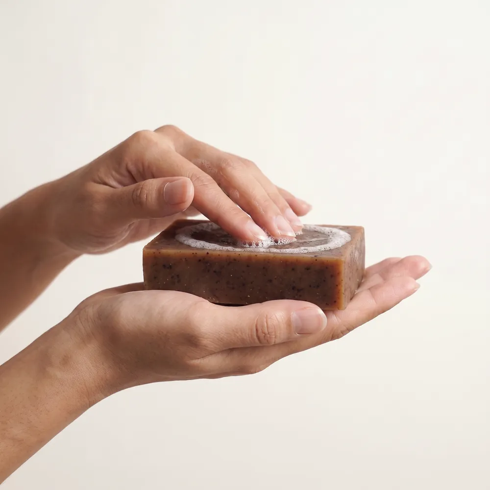 Smilax Aspera Artisanal Soap · hand lathering a soap bar | Lê Mai