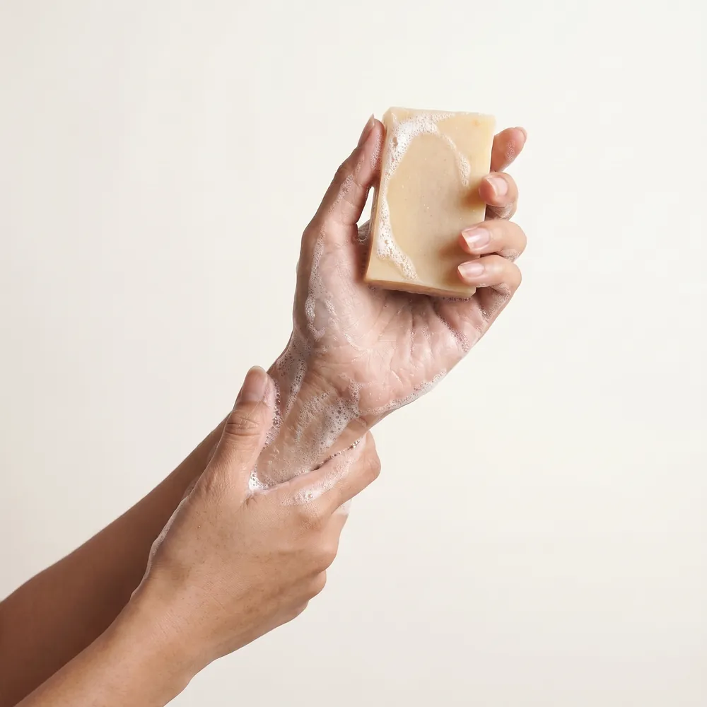 White Wine Artisanal Soap No.101 · hand holding a lathering soap bar | Lê Mai